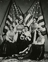 Volunteers in the military trophy booth at the Army Relief Fair in Albany, New York, 1864. Pictured from left to right: Miss Susie Kerney, Miss Bow, Mrs. Benjamin Richards, Mrs. John de P. Townsend, and Miss Thornburn.