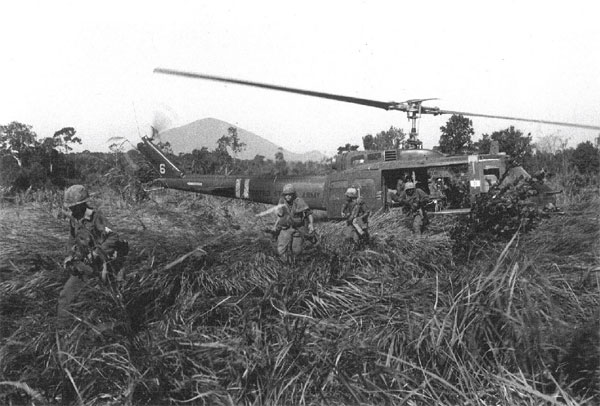 Infantry disembark from a Huey "Slick" during combat operations.  The ability to transport fully armed troops directly to the combat zone made Hueys invaluable to Army commanders.