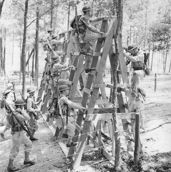 Training Troops to surmount obstacles over steeple chase course, Ft. Belvoir, Va. 1941.